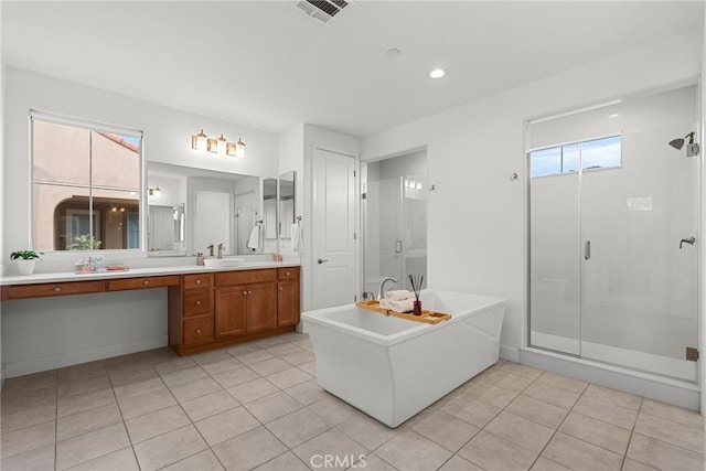 full bathroom with vanity, visible vents, a freestanding bath, a shower stall, and tile patterned floors