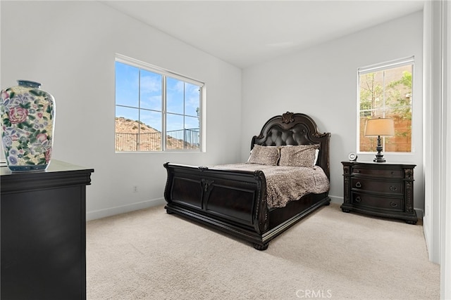 carpeted bedroom with multiple windows and baseboards