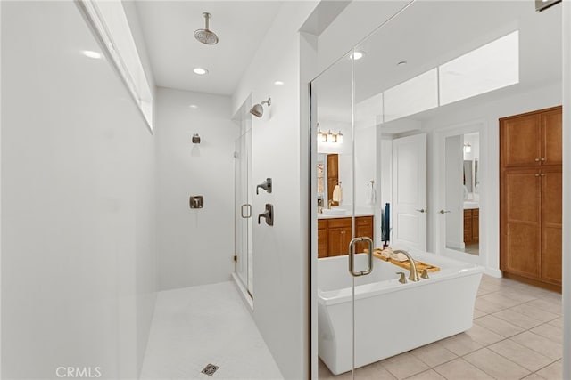 bathroom with recessed lighting, a freestanding bath, a stall shower, vanity, and tile patterned flooring