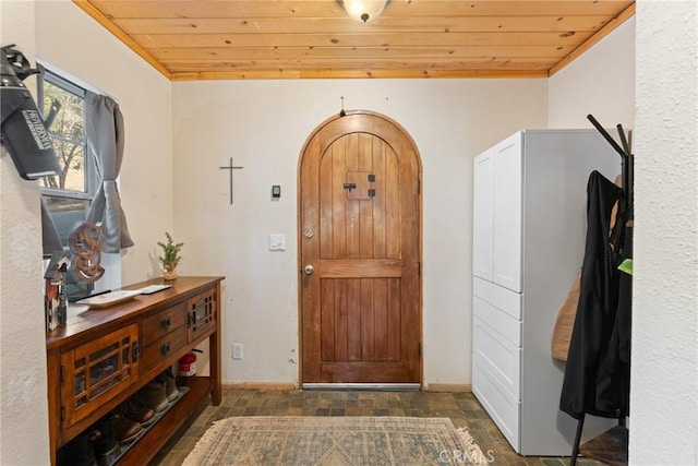 entryway featuring ornamental molding and wooden ceiling