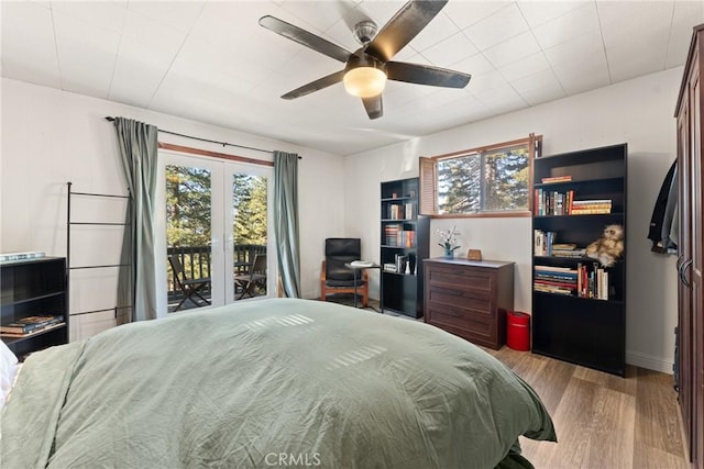 bedroom featuring access to exterior, ceiling fan, and light hardwood / wood-style flooring