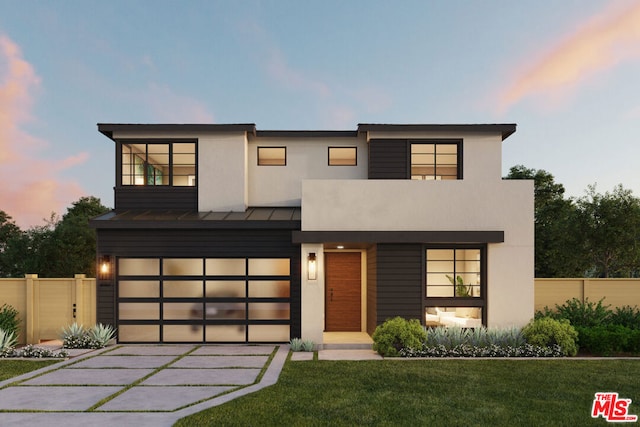 modern home featuring a yard and a garage