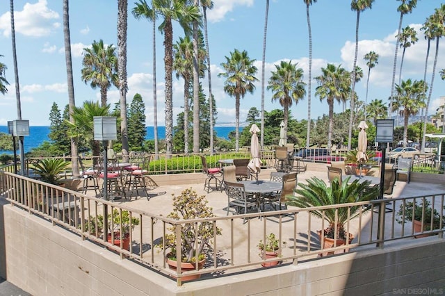 view of home's community with a patio area and a water view