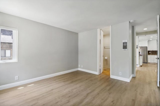 unfurnished room featuring light hardwood / wood-style flooring