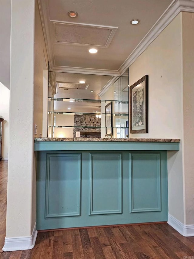 bar with ornamental molding, dark hardwood / wood-style floors, and stone countertops