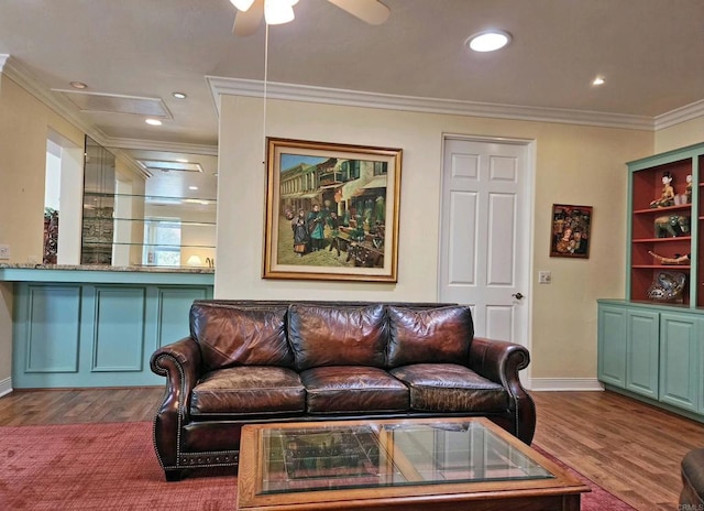 living room featuring hardwood / wood-style flooring, crown molding, and ceiling fan