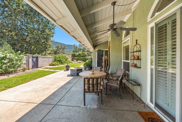 view of patio with ceiling fan and a mountain view