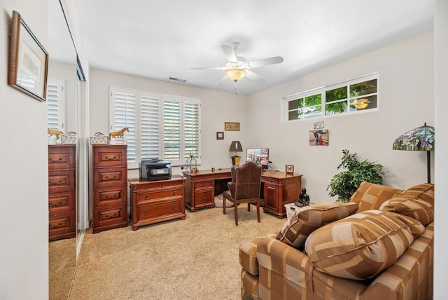 carpeted office space with ceiling fan