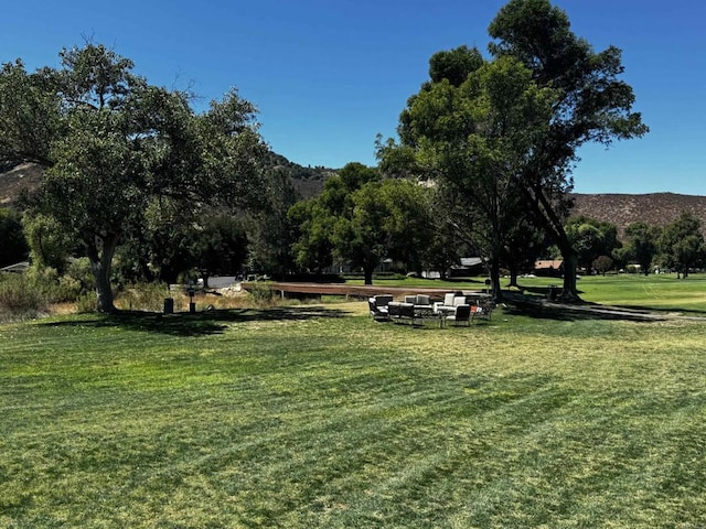 view of property's community featuring a mountain view and a lawn