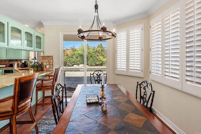 dining area featuring an inviting chandelier and ornamental molding