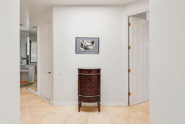 hall with light tile patterned floors