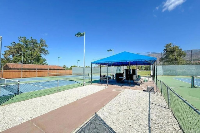 view of tennis court featuring a gazebo