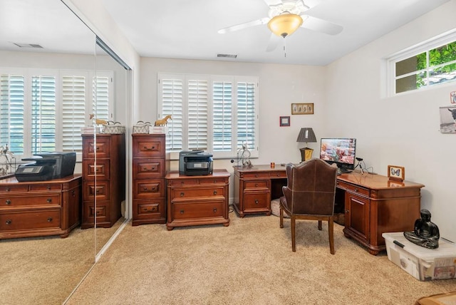 carpeted office featuring ceiling fan