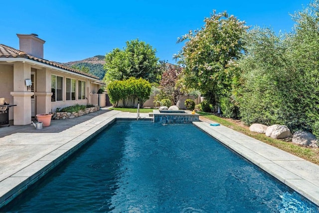 view of pool featuring a mountain view and a patio area