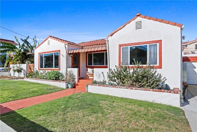 mediterranean / spanish-style house with a front yard