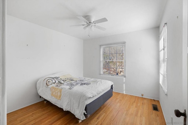 bedroom with ceiling fan and hardwood / wood-style floors