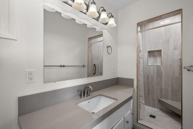 bathroom featuring vanity, a notable chandelier, and tiled shower