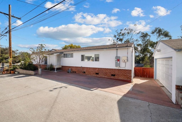 view of front of property featuring a garage and an outdoor structure