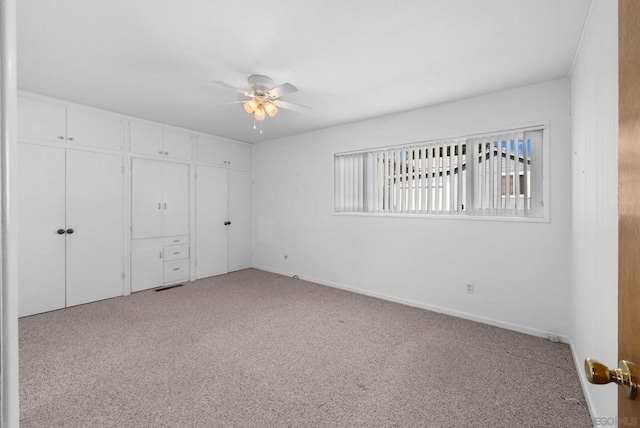 unfurnished bedroom featuring ceiling fan, a closet, and light carpet