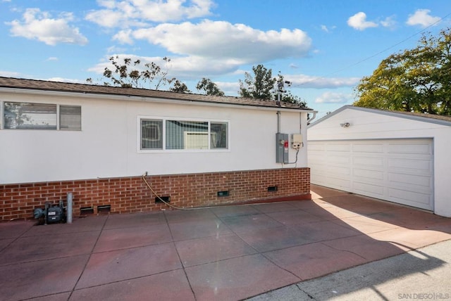 view of side of property with a garage and an outdoor structure