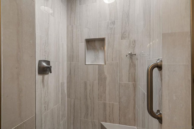 bathroom with tiled shower