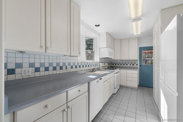 kitchen featuring light tile patterned floors, white appliances, decorative backsplash, and white cabinets