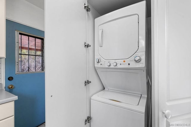 laundry room with stacked washer and clothes dryer