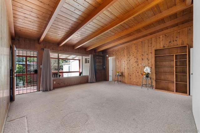 unfurnished room featuring wood ceiling, beam ceiling, carpet floors, and wood walls