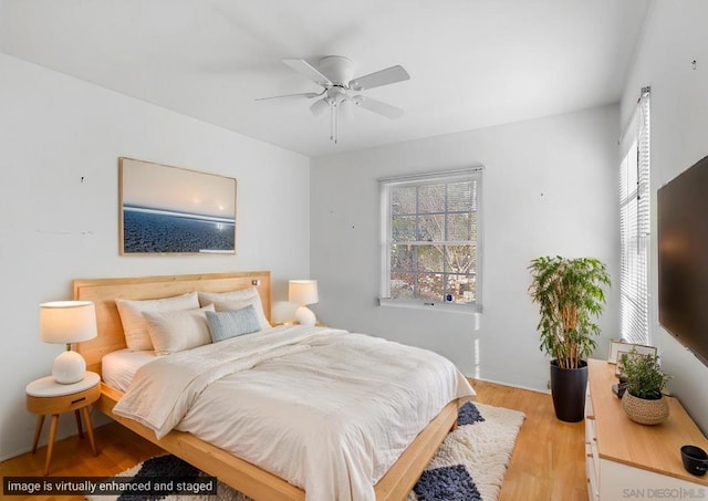 bedroom with ceiling fan and light hardwood / wood-style floors