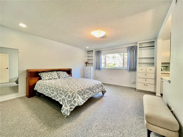 carpeted bedroom with a textured ceiling