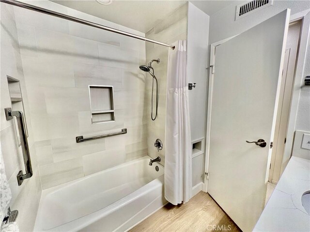 bathroom featuring shower / bathtub combination with curtain and hardwood / wood-style floors