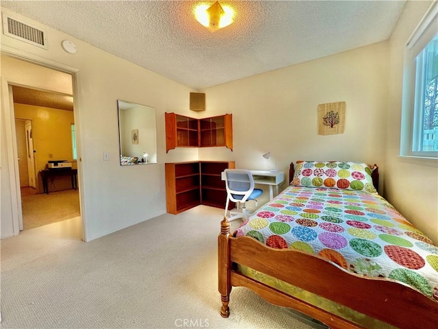 carpeted bedroom featuring a textured ceiling