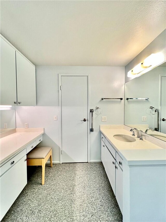 bathroom with vanity and a textured ceiling