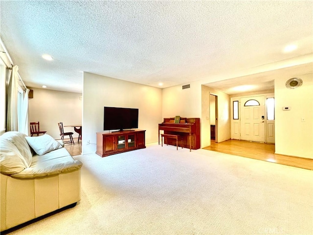 living room with light carpet and a textured ceiling