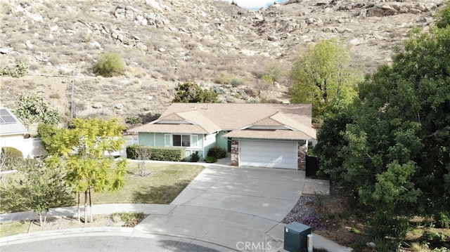 single story home with a garage and concrete driveway