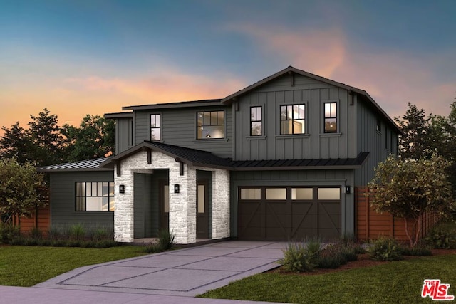 view of front facade with a garage and a lawn