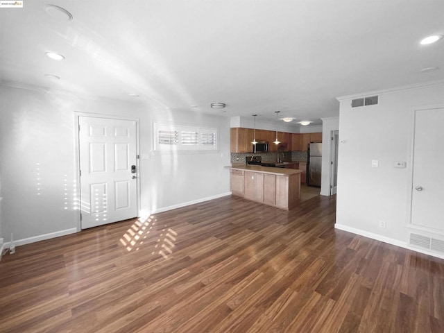 unfurnished living room with crown molding and dark hardwood / wood-style floors