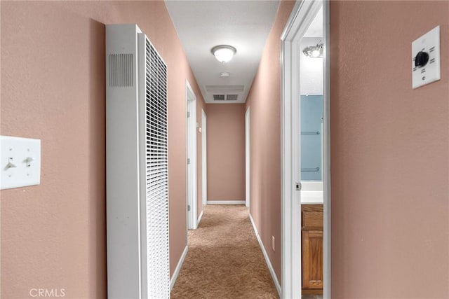 hallway with light colored carpet