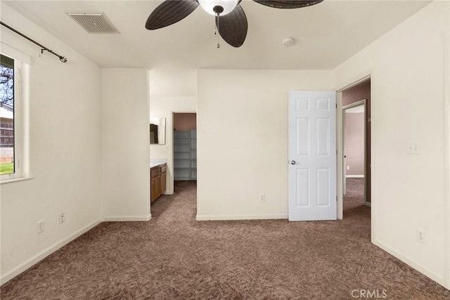 unfurnished bedroom with ensuite bath and carpet