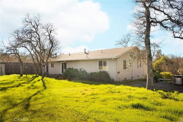 rear view of property with a yard