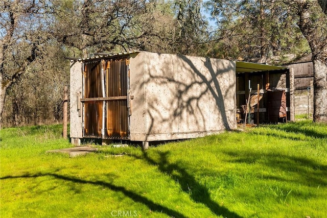 view of outbuilding with a lawn