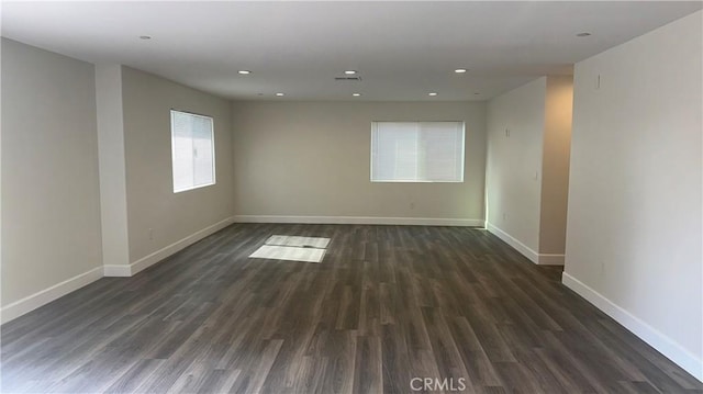 unfurnished room with dark hardwood / wood-style floors