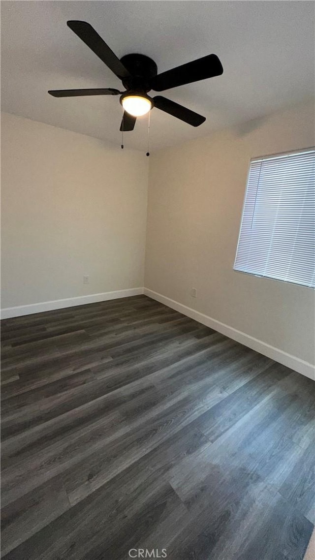 spare room featuring dark wood-type flooring