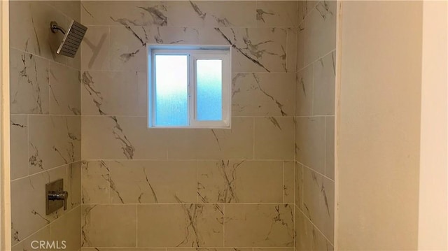 bathroom with tiled shower