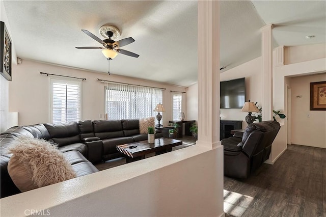 living room featuring lofted ceiling, ceiling fan, dark hardwood / wood-style flooring, and a healthy amount of sunlight