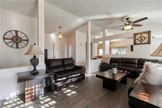 living room featuring ceiling fan, dark hardwood / wood-style floors, and vaulted ceiling