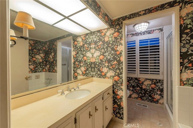 bathroom featuring vanity, a shower with door, and toilet