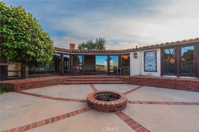 exterior space featuring an outdoor fire pit