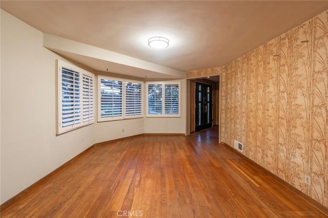 unfurnished room with dark hardwood / wood-style flooring