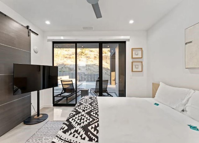 bedroom with ceiling fan, a barn door, and access to outside